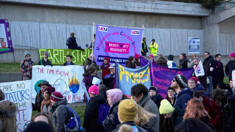 Climate Strike protestors with banners outside the Scottish Parliament