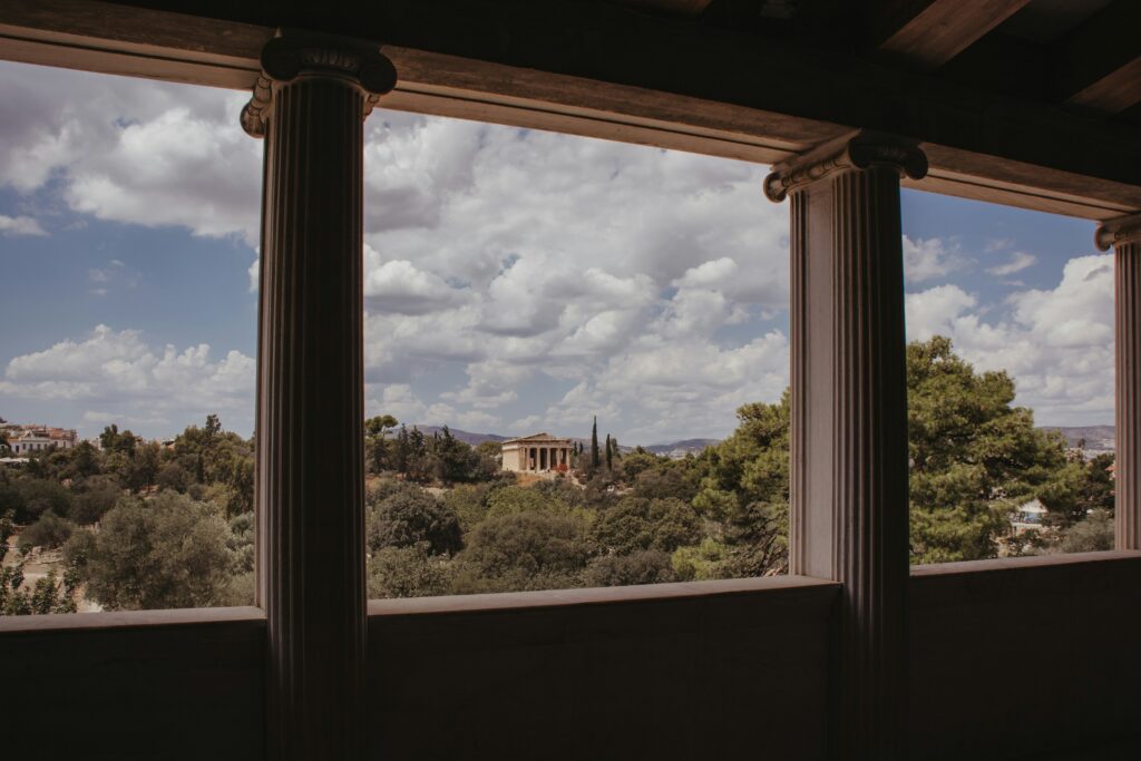 A balcony with columns and a view of Athens