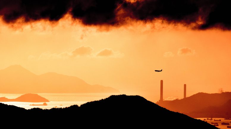 Photo of aeroplane on red sky and with clouds above