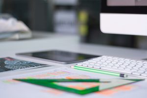 Close-up photo of desk with keyboard and pencil