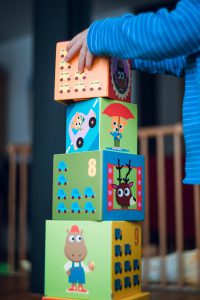 Photo of a child placing blocks on top of each other