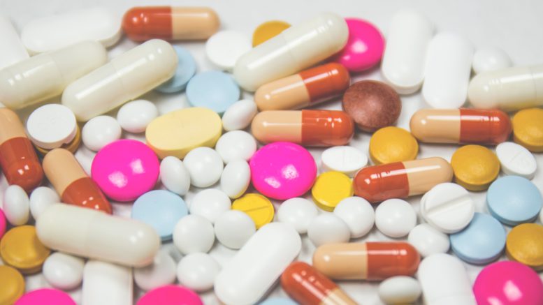 Pills of different colours on a table