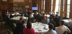 Photo of event in Glasgow City Chambers with people sitting round the tables