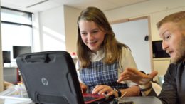 Student and teacher at laptop