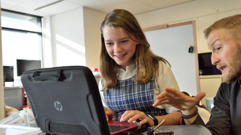 Student and teacher at laptop