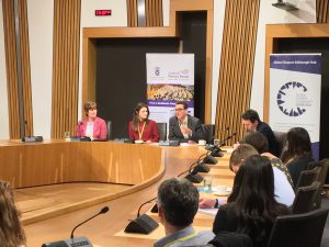 Photo of event with people sitting around a committee room table in the Scottish Parliament