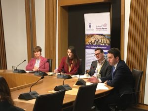 Photo of event with people sitting around a committee room table in the Scottish Parliament