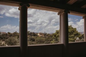 A balcony with columns and a view of Athens