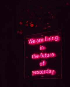 Pink neon sign which says: We are living in the future of yesterday