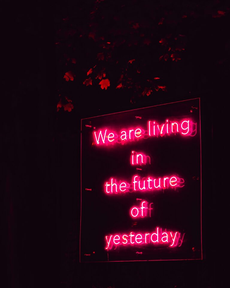 Pink neon sign which says: We are living in the future of yesterday
