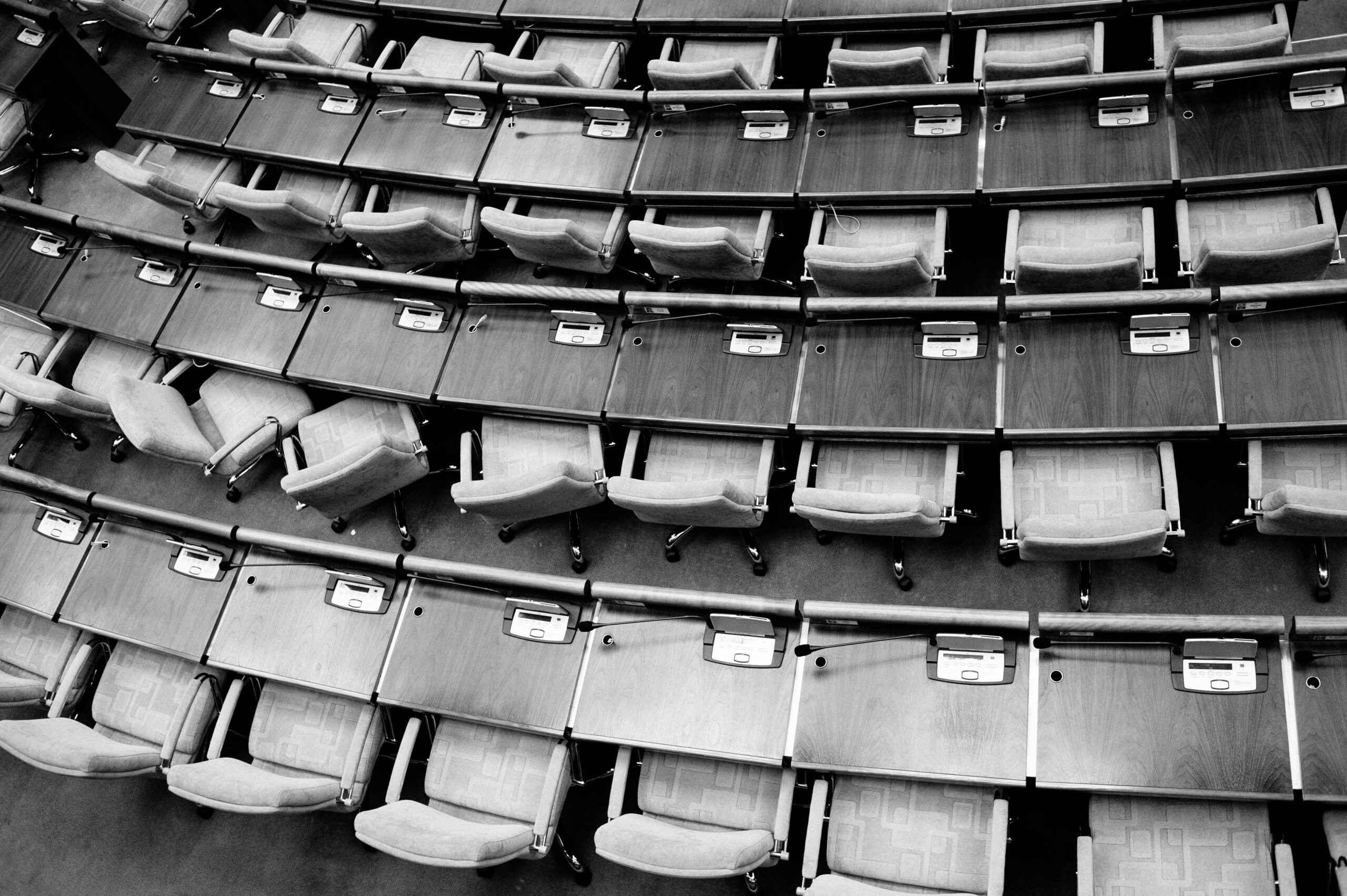 Monochrome downward facing photo of parliamentary seats